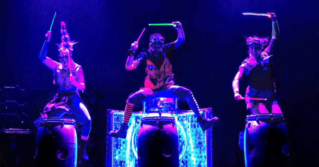 glow in the dark drumming by 3 circus perfomers